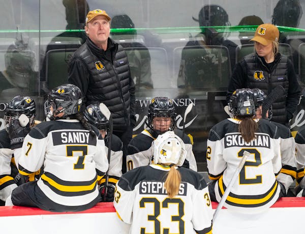 Warroad head coach David Marvin looks up at the scoreboard during a timeout in the second period of the Class 1A girl’s hockey championship Feb. 25 