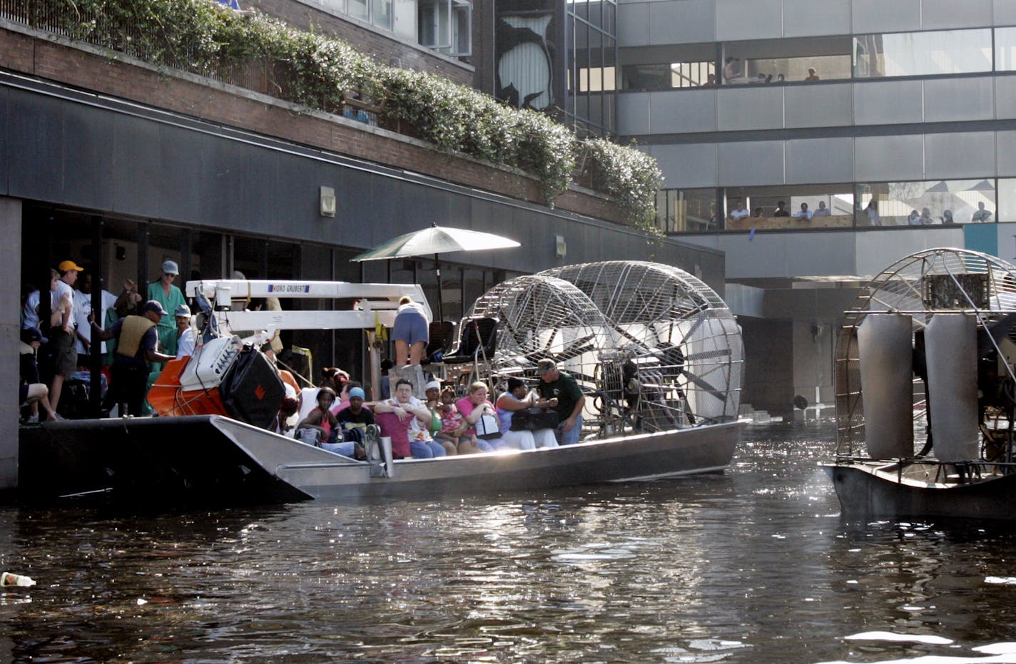 An airboat pulls up to the Memorial Medical Center in New Orleans on Wednesday, Aug. 31, 2005. Floodwaters continue to rise in the Crescent City after several levees broke, inundating the city in the wake of Hurricane Katrina. Airboats were used to evacuate patients and staff of the hospital. (AP Photo/Bill Haber)