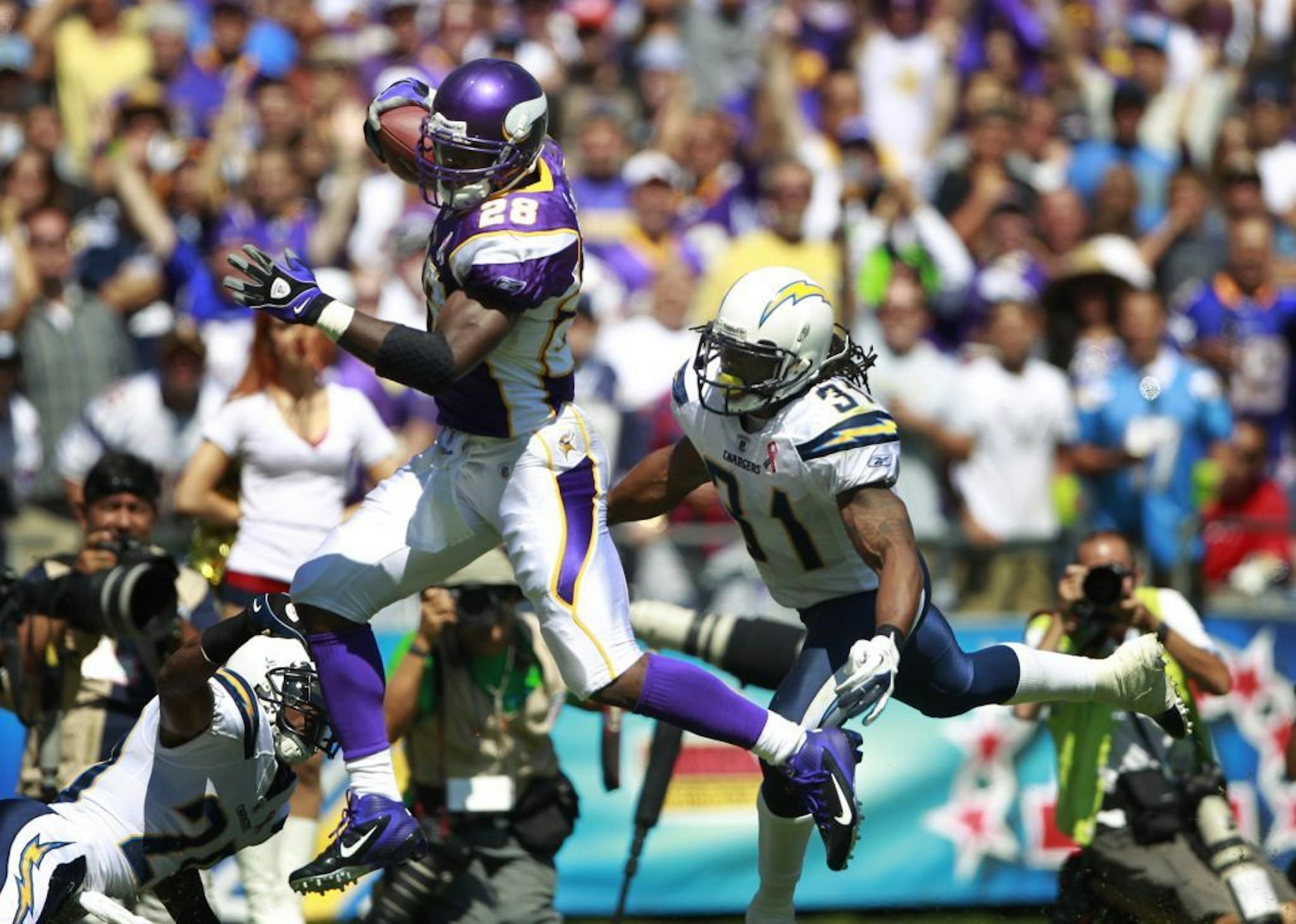 Vikings Adrian Peterson broke the tackle of Chargers Bob Sanders on a 46 yard run in the second quarter during Sunday's September 11,2011 game between the Minnesota Vikings and San Diego Chargers at Qualcomm Stadium in San Diego, CA.