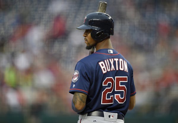 Minnesota Twins' Byron Buxton (25) looks on during the third inning of an interleague exhibition baseball game against the Washington Nationals, Frida