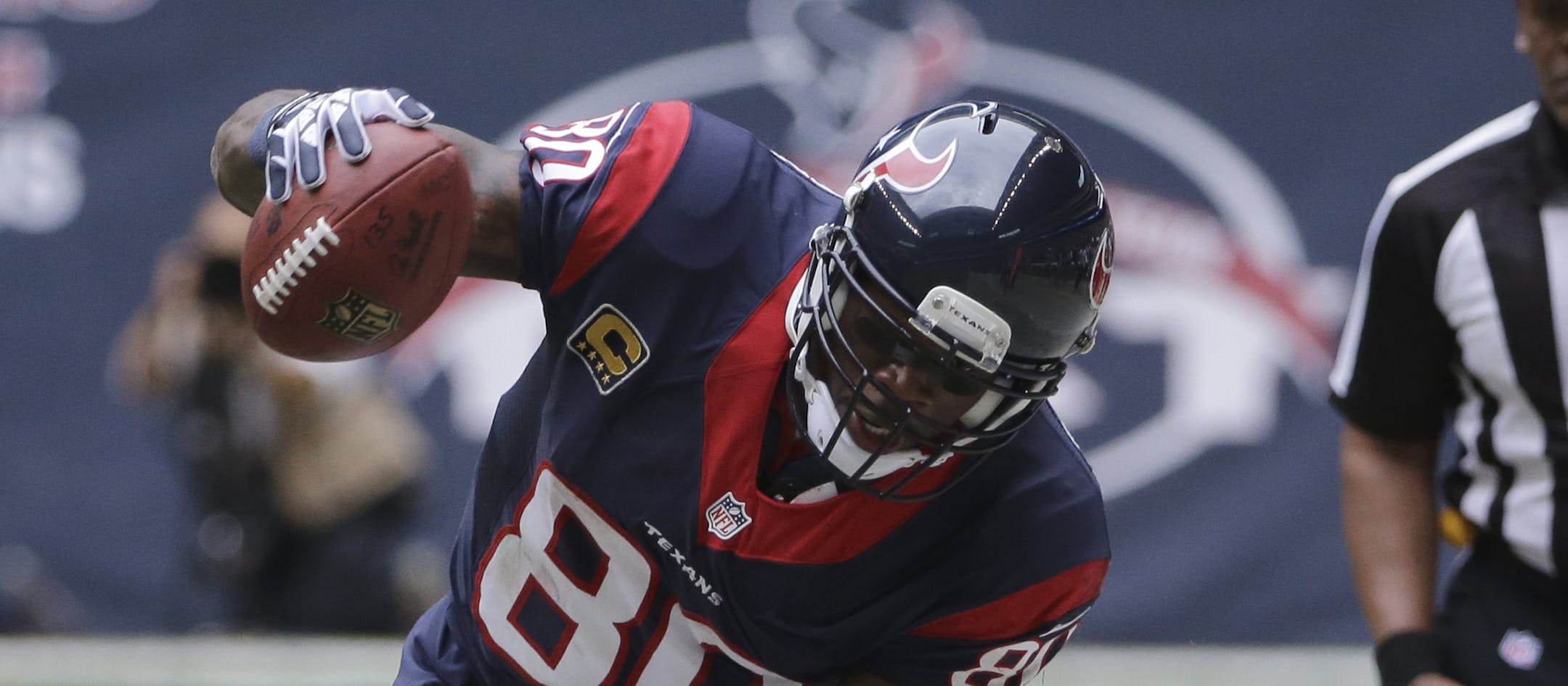 Houston Texans' Andre Johnson (80) works to stay inbounds after making a catch as New England Patriots' Aqib Talib (31) looks on during the third quarter of an NFL football game Sunday, Dec. 1, 2013, in Houston. (AP Photo/David J. Phillip)