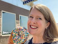 Kara Johnson samples a sprinkle doughnut at Dutch Maid Bakery in Sauk Rapids.