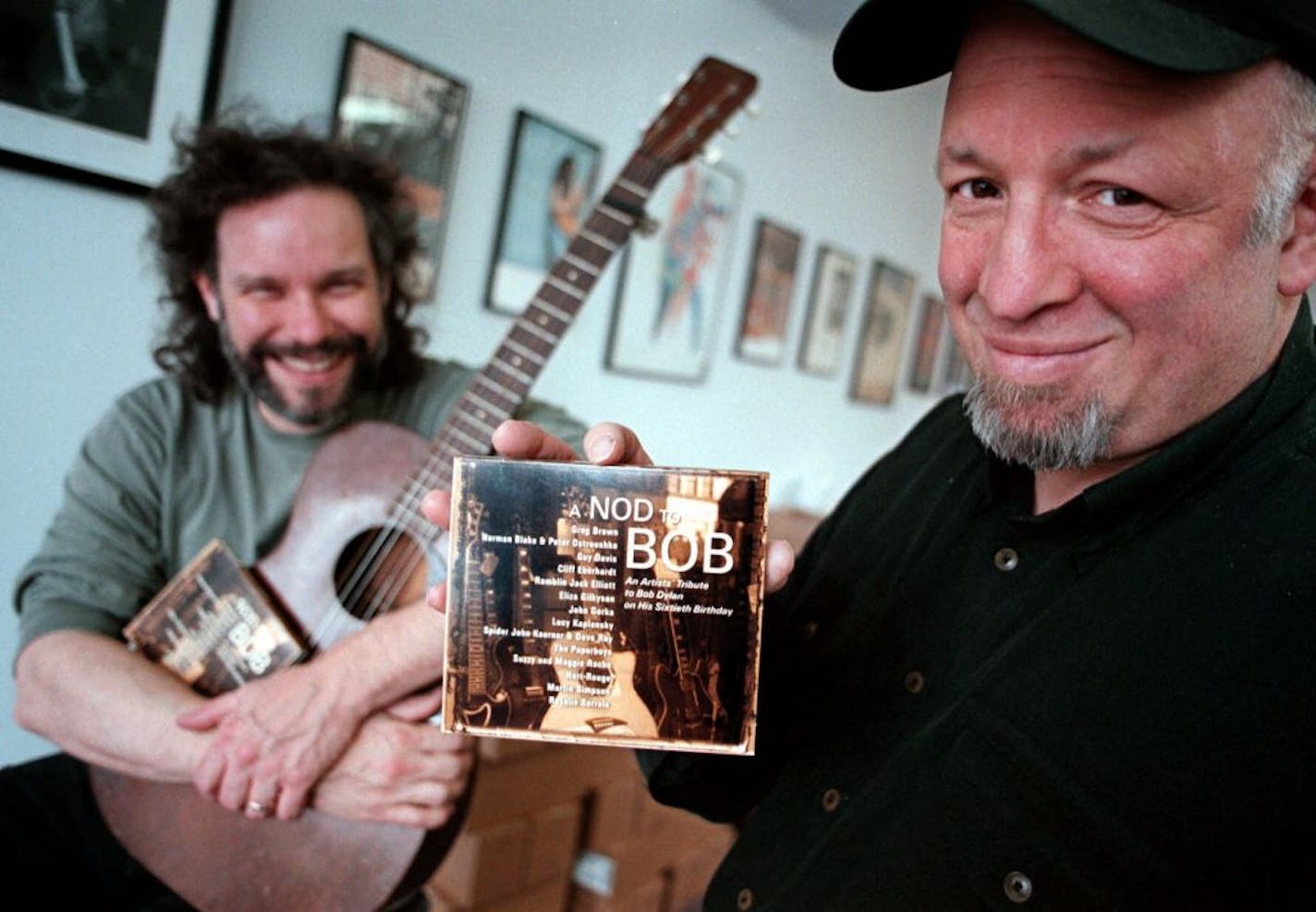 Red House Records President Bob Feldman, right, holds a CD tribute called "A Nod To Bob," at the Red House Records offices in St. Paul, Minn. in this April 10, 2001, file photo. The CD was issued to celebrate Bob Dylan's 60th birthday. Feldman, who worked to keep the spirit of folk music alive with his independent label, died Wednesday, Jan. 11, 2006, at his home in St. Paul, said Eric Peltoniemi, Red House vice president of production. He was 56. Musician John Gorka, who performed on the record