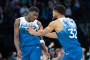 Minnesota Timberwolves guard Anthony Edwards (5) is pushed by center Karl-Anthony Towns (32) after hitting a clutch shot late in the fourth quarter ag