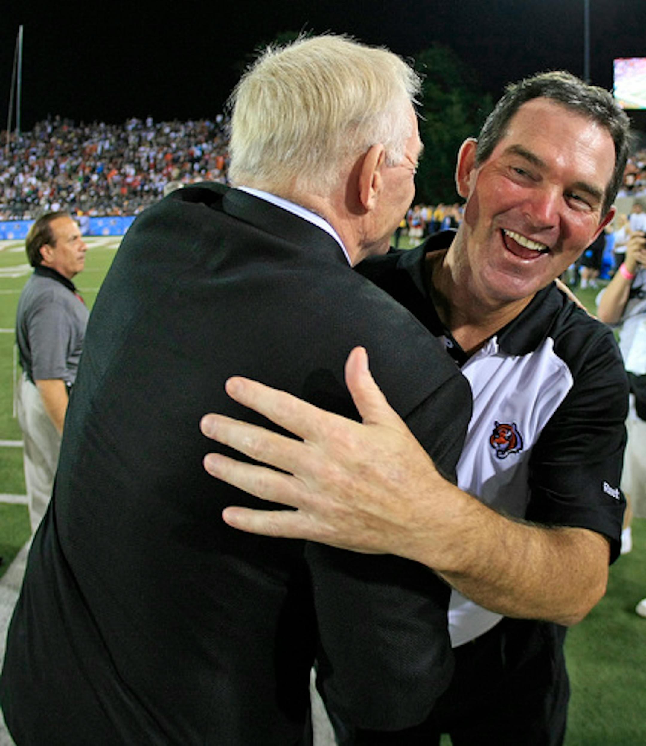Dallas Cowboys owner Jerry Jones (left) hugs Cincinnati Bengals defensive coordinator Mike Zimmer (right) during an NFL preseason football game, Sunday, August 8, 2010 at Pro Football Hall of Fame Field at Fawcett Stadium in Canton, Ohio.  The Cowboys won the game, 16-7. (AP Photo/James D Smith)  ORG XMIT: JSOH01