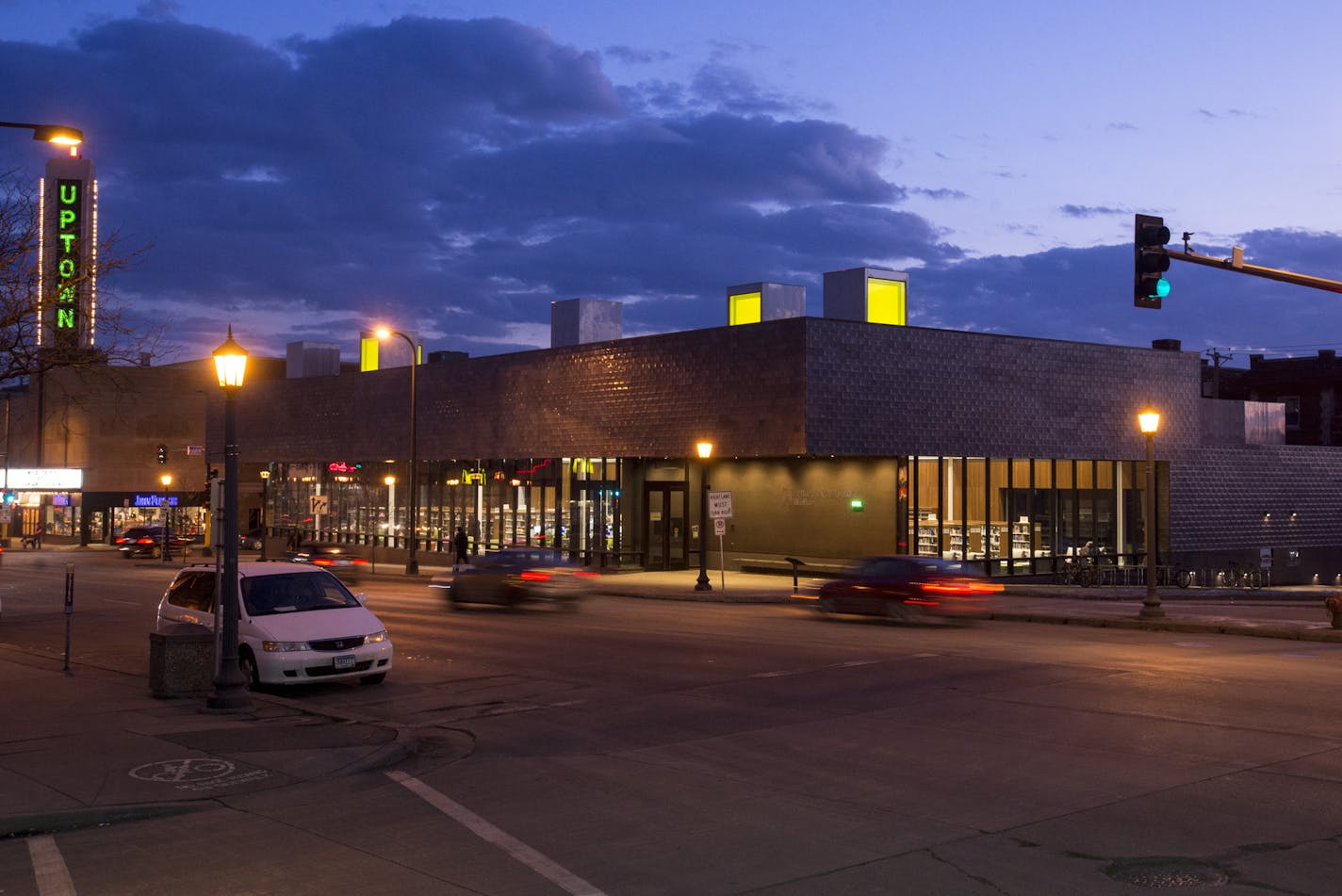 Cars pass the newly built Walker Library on Hennepin Avenue.