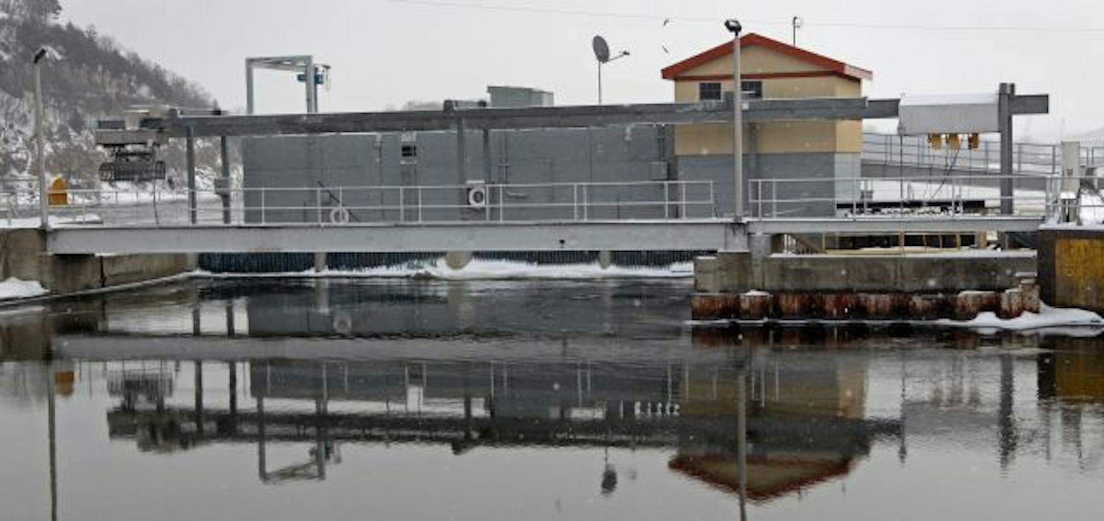 (left to right) Water at the inlet reflected the Hastings Hydroelectric plant. The power plant is located at Lock and Dam #2, on the Mississippi river, just north of downtown Hastings.