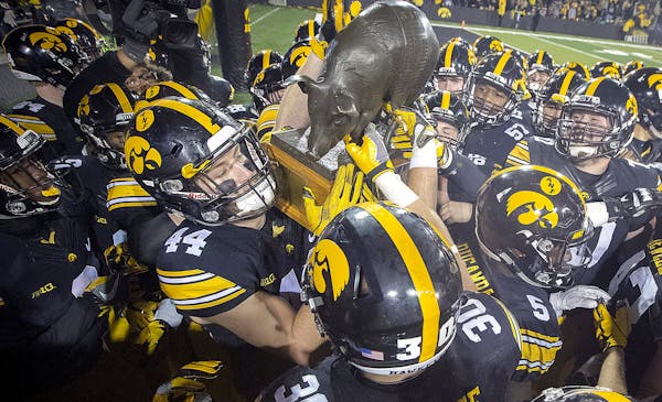 The "Floyd of Rosedale Trophy" is picked up by the Iowa team after they defeated Minnesota 17-10 at Kinnick Stadium, Saturday, October 28, 2017 in Iow