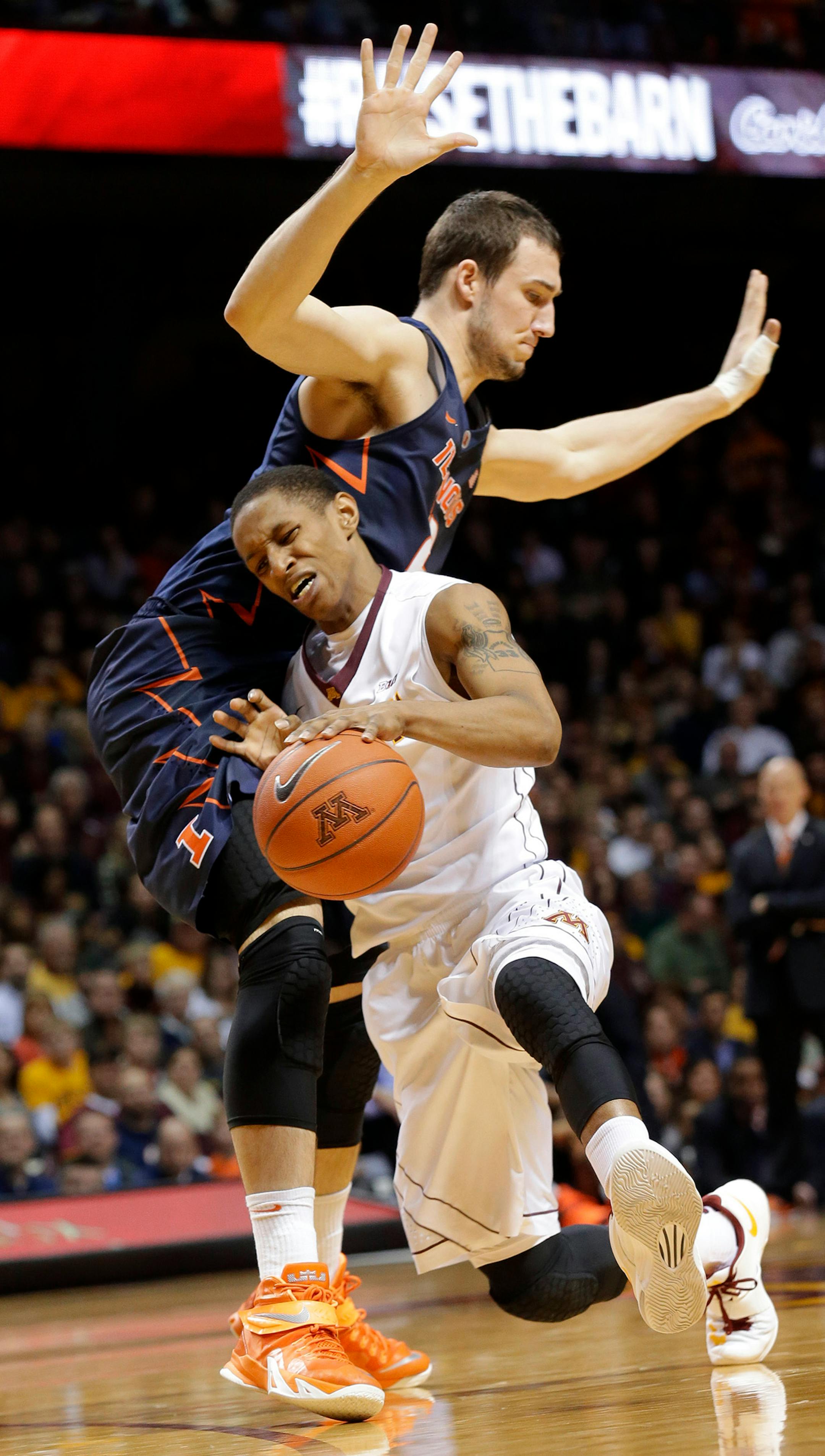 Minnesota guard DeAndre Mathieu, bottom, drives against Illinois center Maverick Morgan, top, during the second half of an NCAA college basketball game in Minneapolis, Saturday, Jan. 24, 2015. (AP Photo/Ann Heisenfelt)