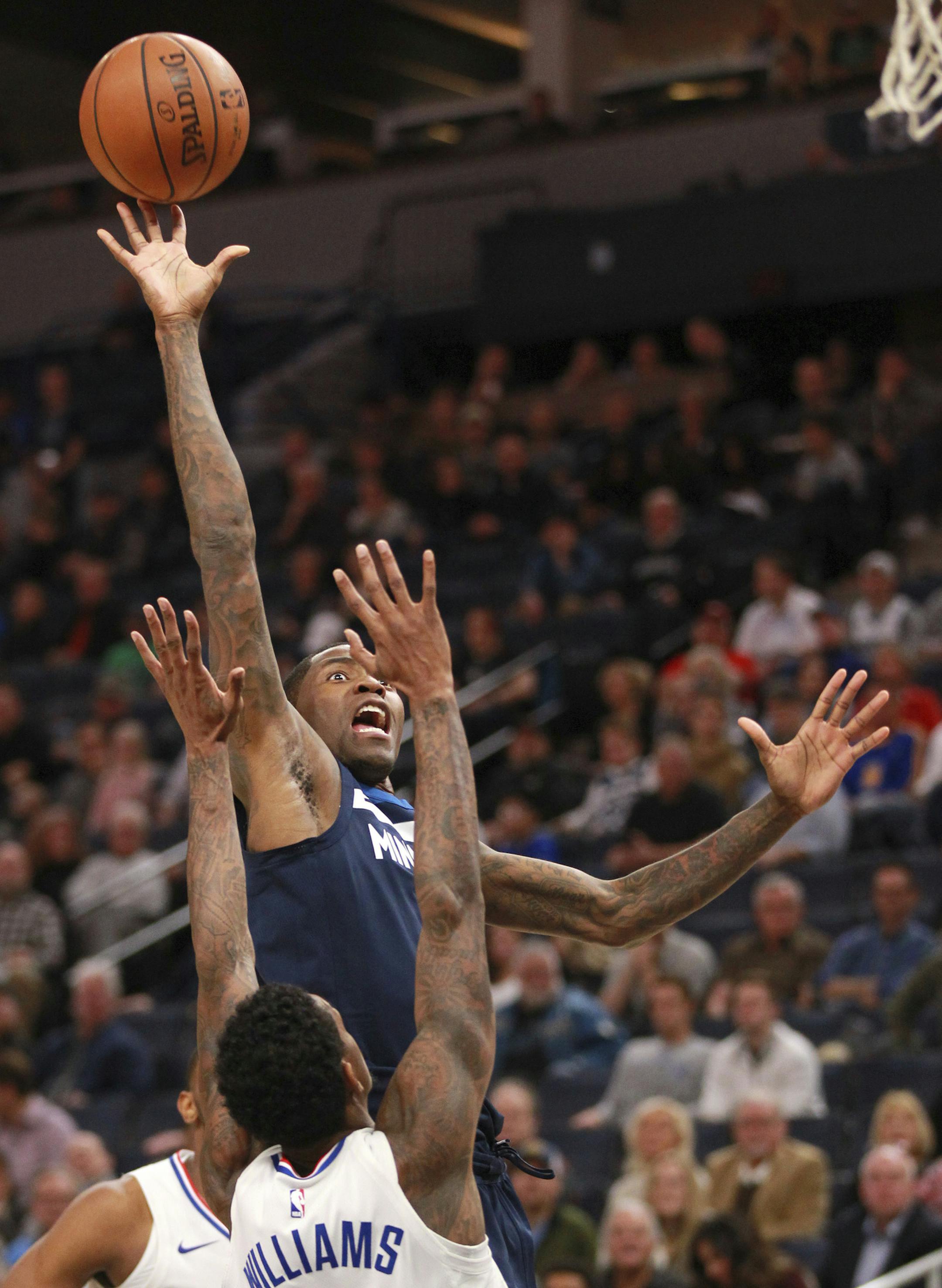 Minnesota Timberwolves guard Jamal Crawford (11) shoots over Los Angeles Clippers guard Lou Williams (23) in the first quarter of an NBA basketball game on Sunday, Dec. 3, 2017, in Minneapolis. (AP Photo/Andy Clayton-King)