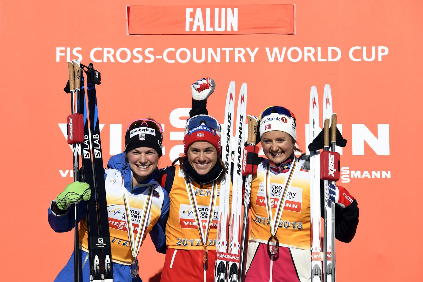 Norway's Marit Bjoergen who finished in first place, centre, poses for a photo on the podium with second placed Jessica Diggins of the United States, left and Sadie Bjornsen of the United States at the podium after the 10km cross country free style event of the Cross Country World Cup, in Falun, Sweden, Sunday March 18, 2018. (Ulf Palm /TT News Agency via AP)