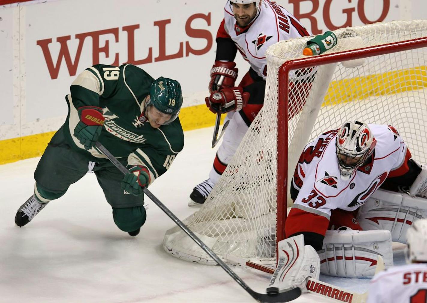 Wild Stephane Veilleux, 19, tries to stuff one into the goal against Carolina goalie, Brian Boucher, 33, in the first period.