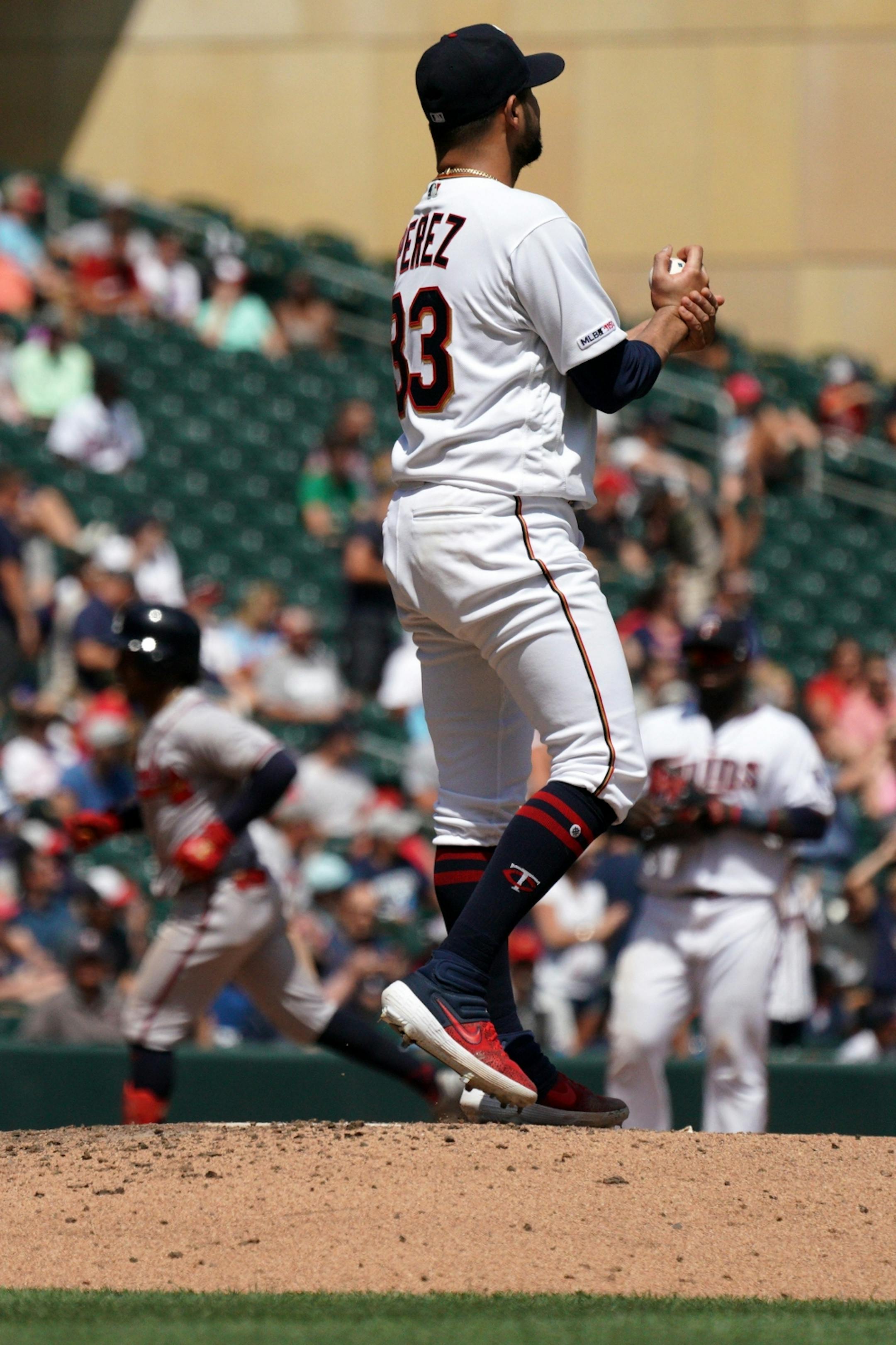 Minnesota Twins starting pitcher Martin Perez (33) stood on the mound as Atlanta Braves second baseman Ozzie Albies (1) rounded the bases after hitting a solo home run in the sixth inning.