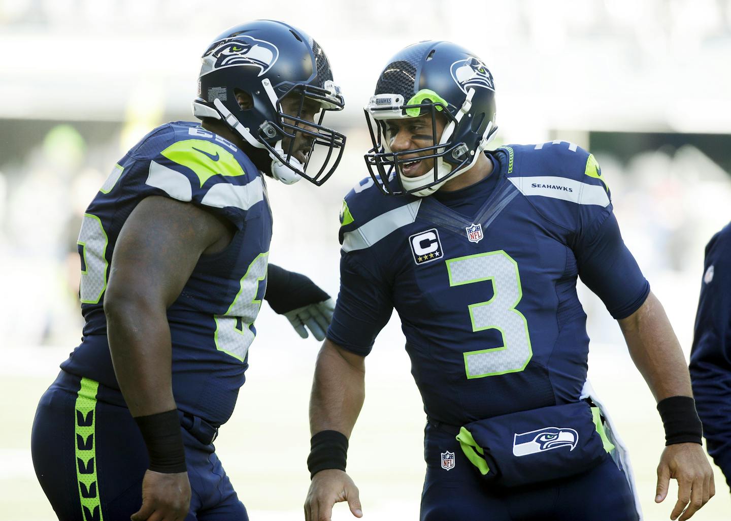 Seattle Seahawks quarterback Russell Wilson (3) talks with center Patrick Lewis, left, before an NFL football game against the San Francisco 49ers, Sunday, Nov. 22, 2015, in Seattle. (AP Photo/Elaine Thompson)