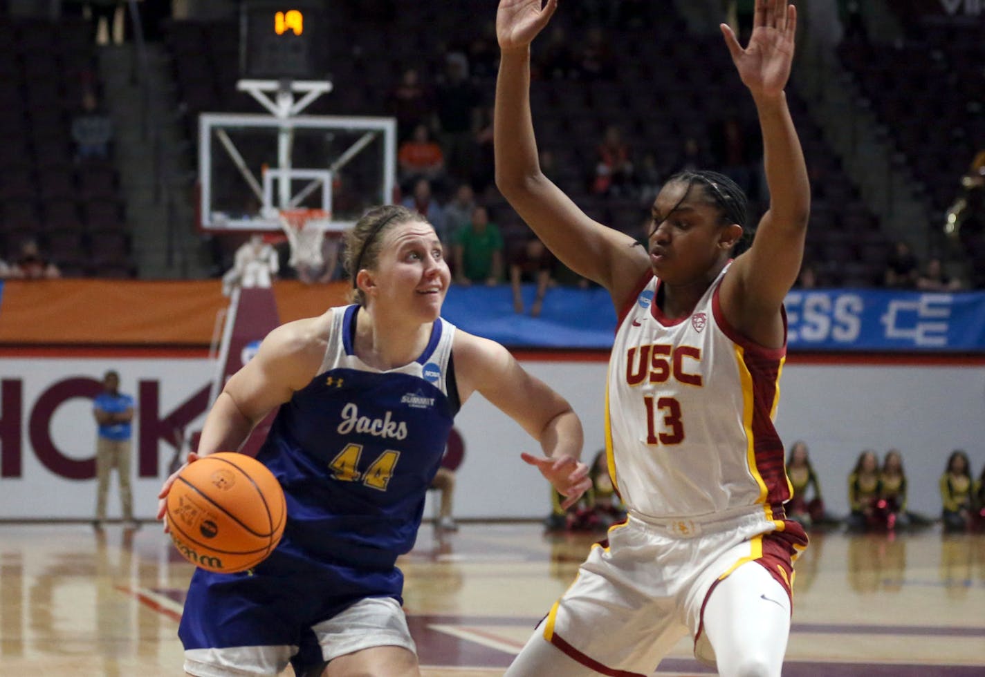 South Dakota State's Myah Selland (44) drives on Southern California's Rayah Marshall (13) during the fourth quarter of a first-round college basketball game in the women's NCAA Tournament, Friday, March 17, 2023, in Blacksburg, Va. (AP Photo/Matt Gentry)