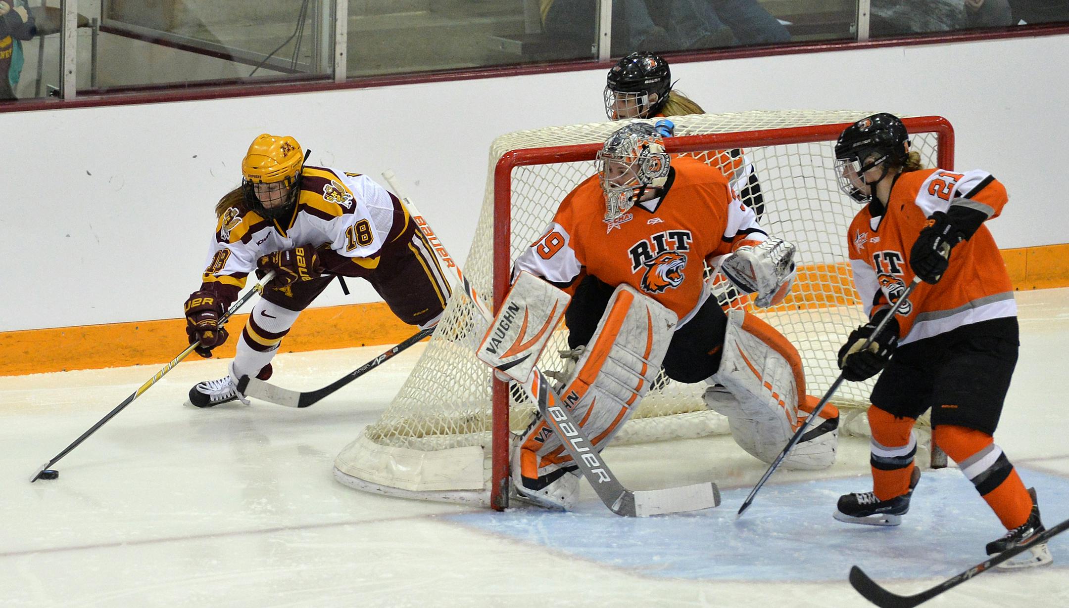 Minnesota right wing junior Brook Garzone attempts to slip the puck past RIT goaltender Ali Binnington during the first period of the NCAA quarterfinals.