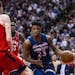 Minnesota Timberwolves guard Jimmy Butler (23) is defended by Toronto Raptors forward Pascal Siakam (43) and center Jakob Poeltl during the second hal