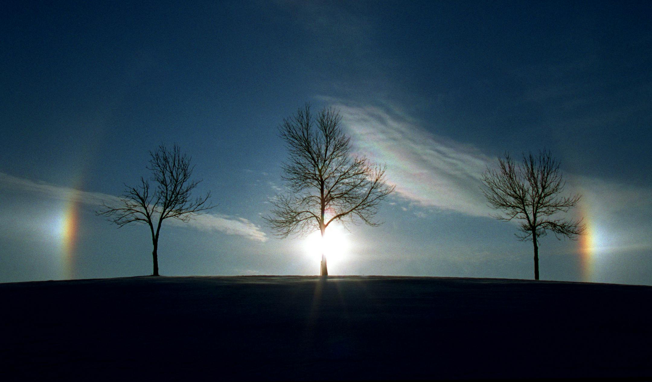 "Who let the sunDOGS out? As the sun crawled into the southeastern sky on the shortest day of the year (Winter Solstice), sundogs, also called mock suns or parhelia, appeared as sunlight refracted through ice crystals in cirroform clouds. Winter Solstice has been celebrated in cultures the world over for thousands of years. This start of the solar year is a celebration of light and the rebirth of the Sun. In old Europe, it was known as Yule, from the Norse, Jul, meaning wheel. Today, many people