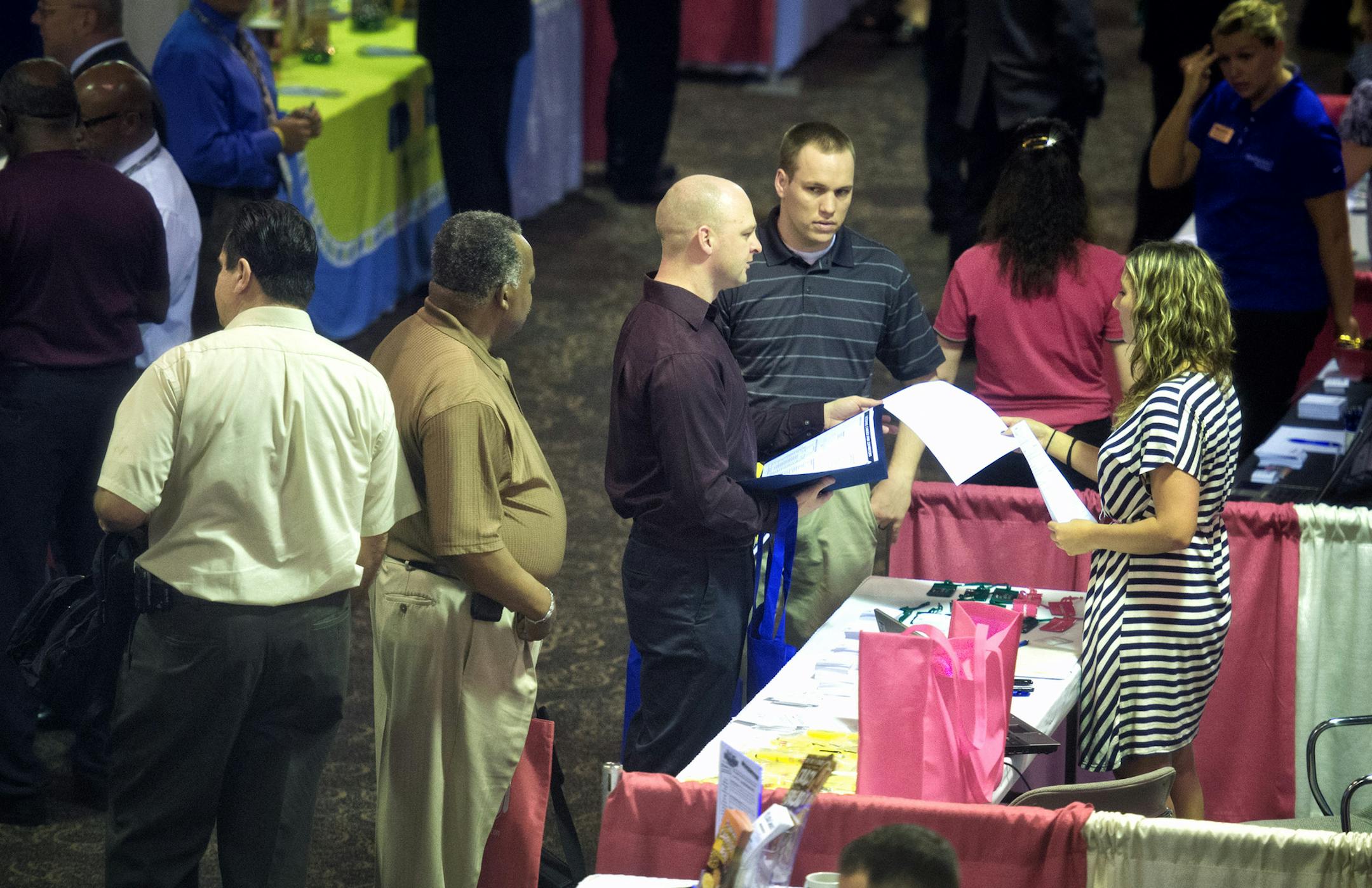 Army Reservist Nathan Stevens handed a résumé to Carlson Wagonlit Travel recruiter Aly Cooper. Stevens’ orders go through the end of the year, when he and Nathan Sieback, right, will become civilians. During Hire a Veteran Month, the Department of Employment and Economic Development sponsored a Veterans Career Fair in Brooklyn Center to connect more than 1,200 veterans and military members seeking jobs with 135 companies looking for workers.