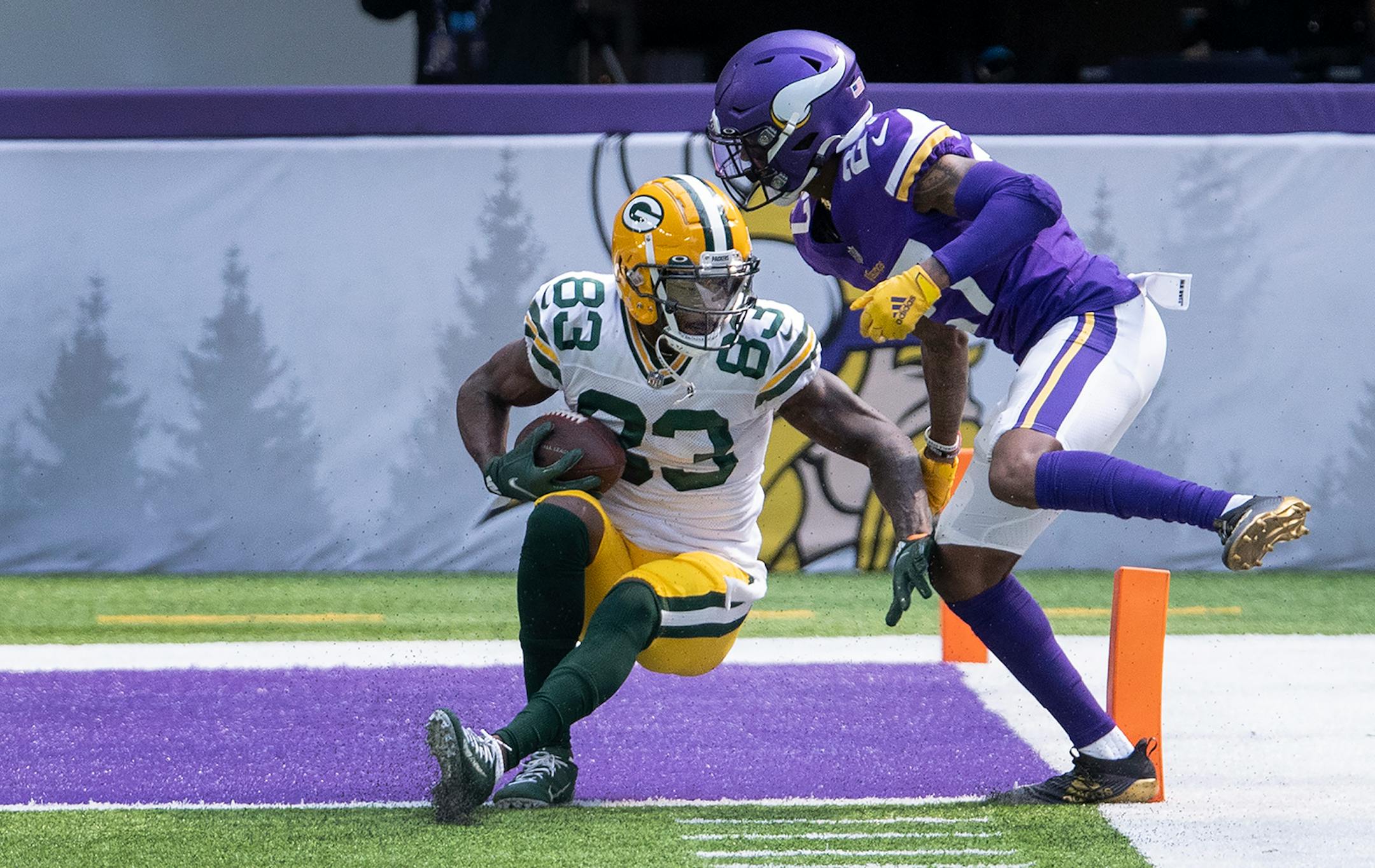 Green Bay Packers receiver Marquez Valdes-Scantling (83) caught a touchdown pass while being defended by Minnesota Vikings rookie defensive back Cameron Dantzler (27) in the second quarter.