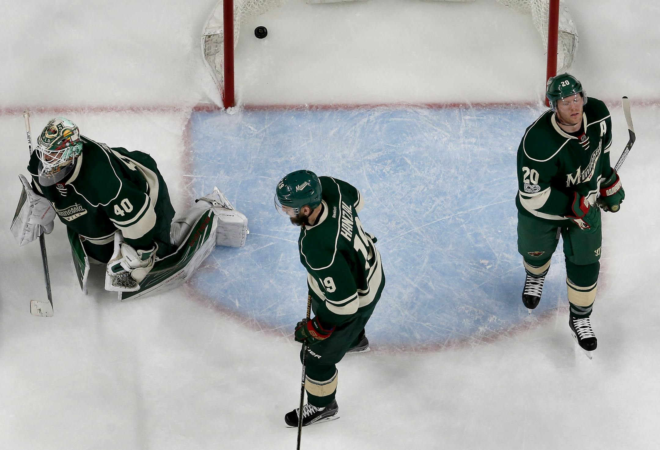 Minnesota Wild players Devan Dubnyk (40), Martin Hanzal (19), Ryan Suter (20) after the overtime loss to the St. Louis Blues.