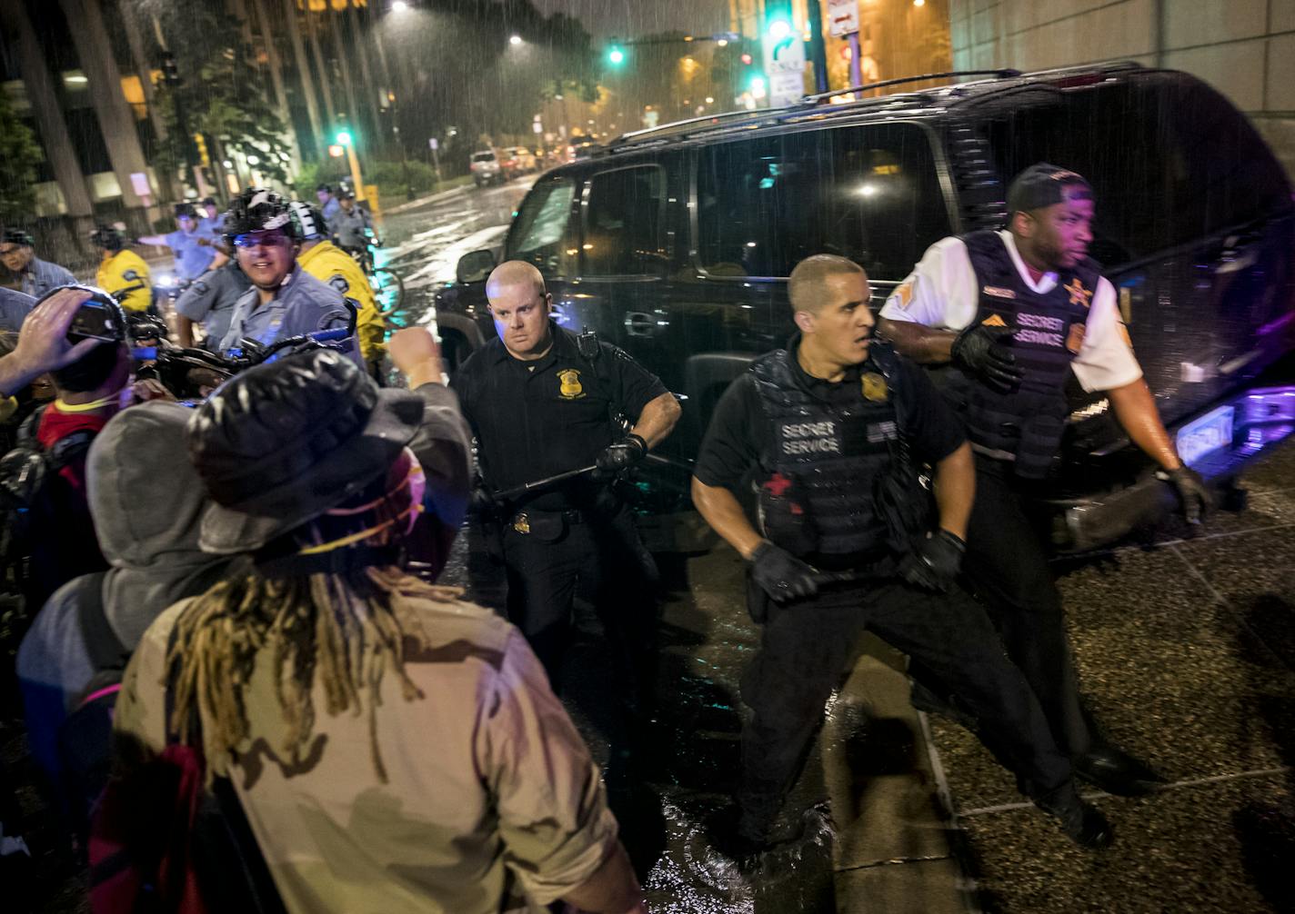 Police pushed back forceful protesters in a tense moment as Donald Trump's motorcade left a fundraiser at the Minneapolis Convention Center on August 19, 2016, in Minneapolis, Minn. ] RENEE JONES SCHNEIDER &#x2022; renee.jones@startribune.com