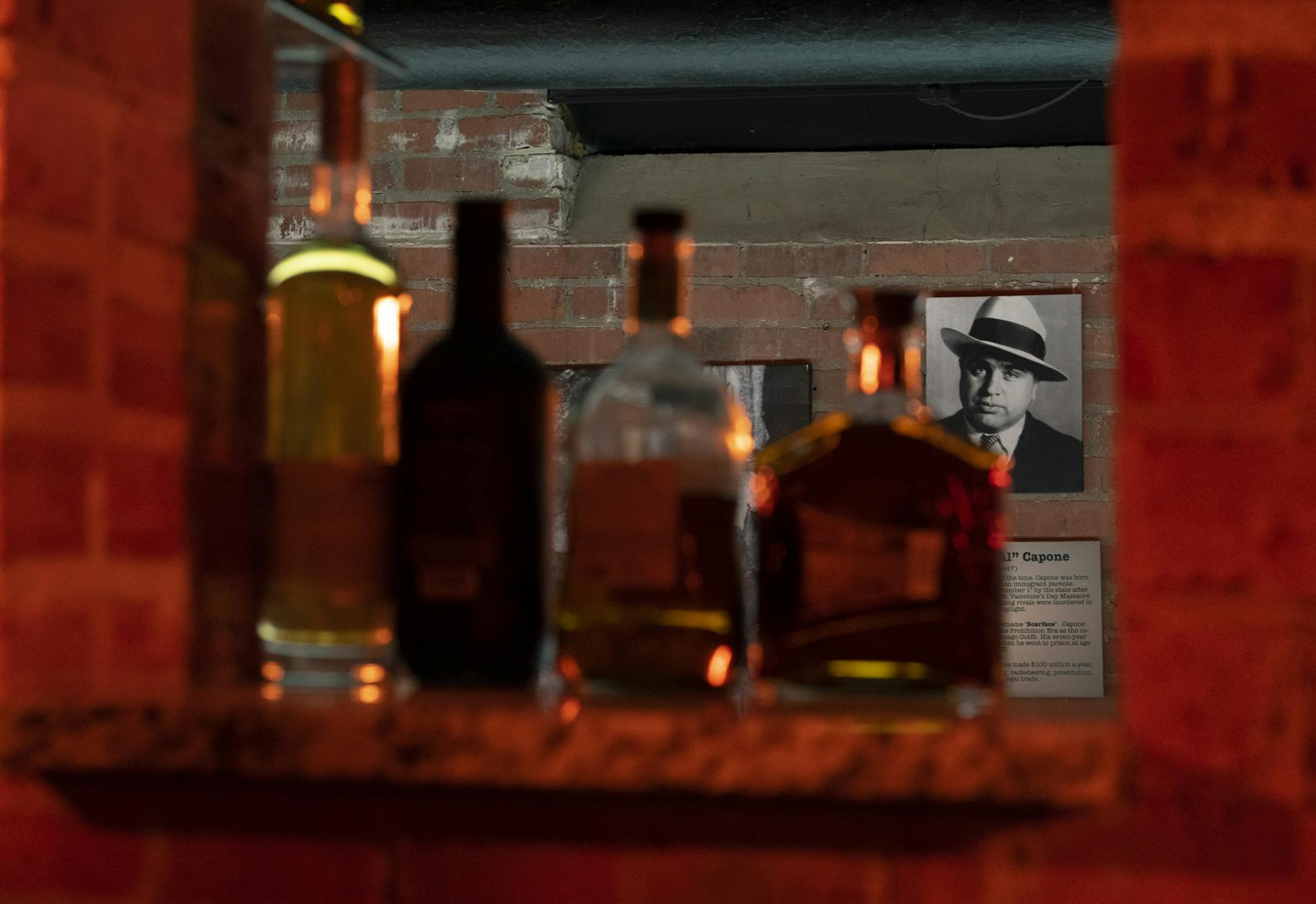 A photo of Al Capone presides over the bar of Nucky's Speakeasy.