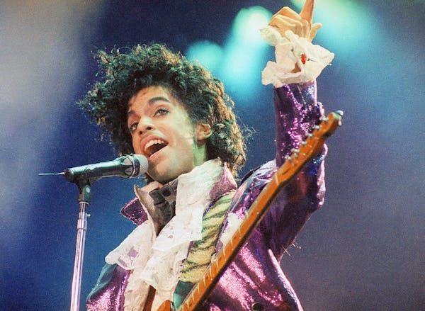 In this Feb. 18, 1985 file photo, Prince performs at the Forum in Inglewood, Calif.