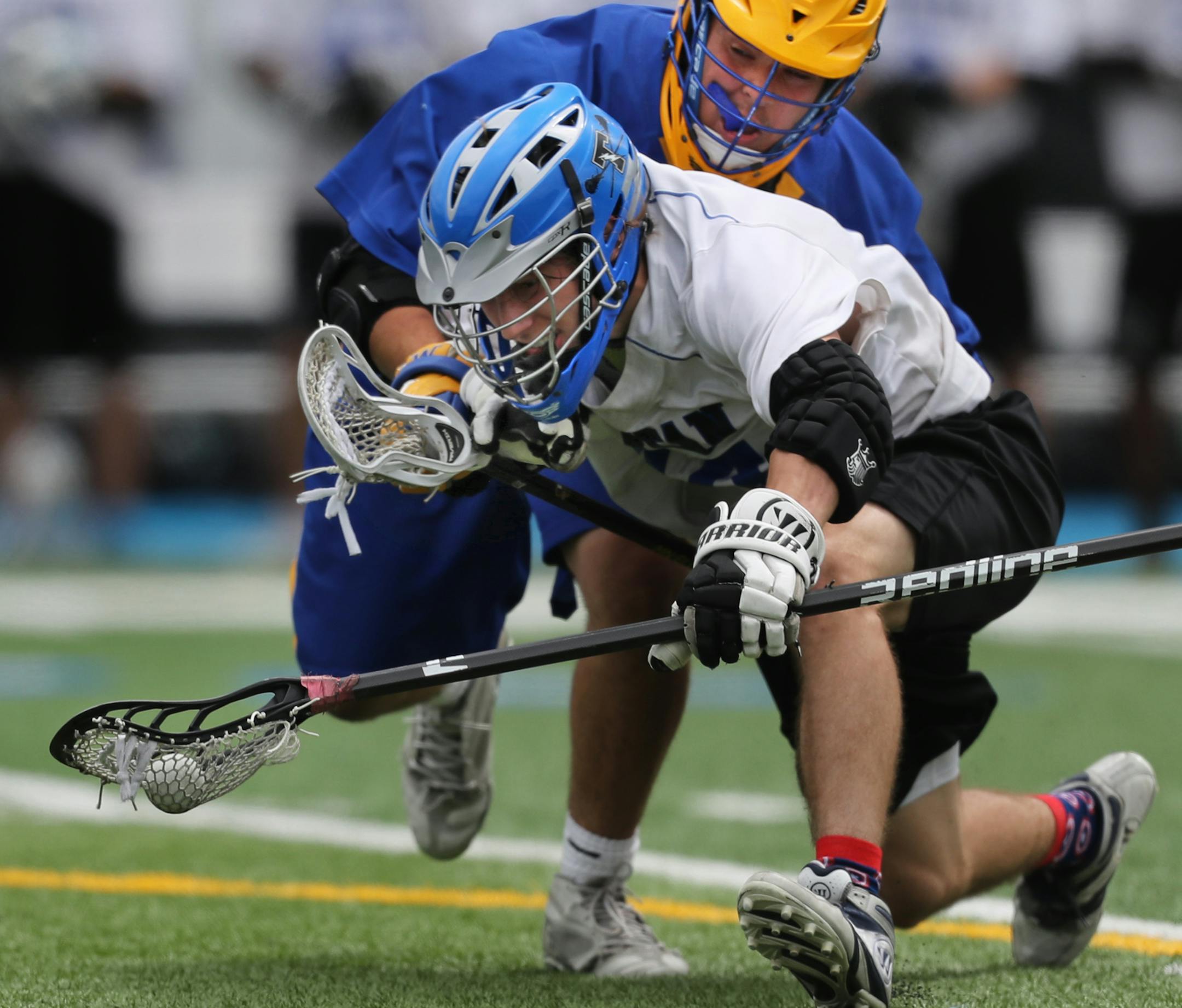 Wayzata player Amar Batra(29) battles Christopher Acker(44), front for control of the ball.[At Minnetonka H.S. in a quarter final lacrosse game between Wayzata and the Tartans, .Richard Tsong-Taatarii/rtsong-taatarii@startribune.com