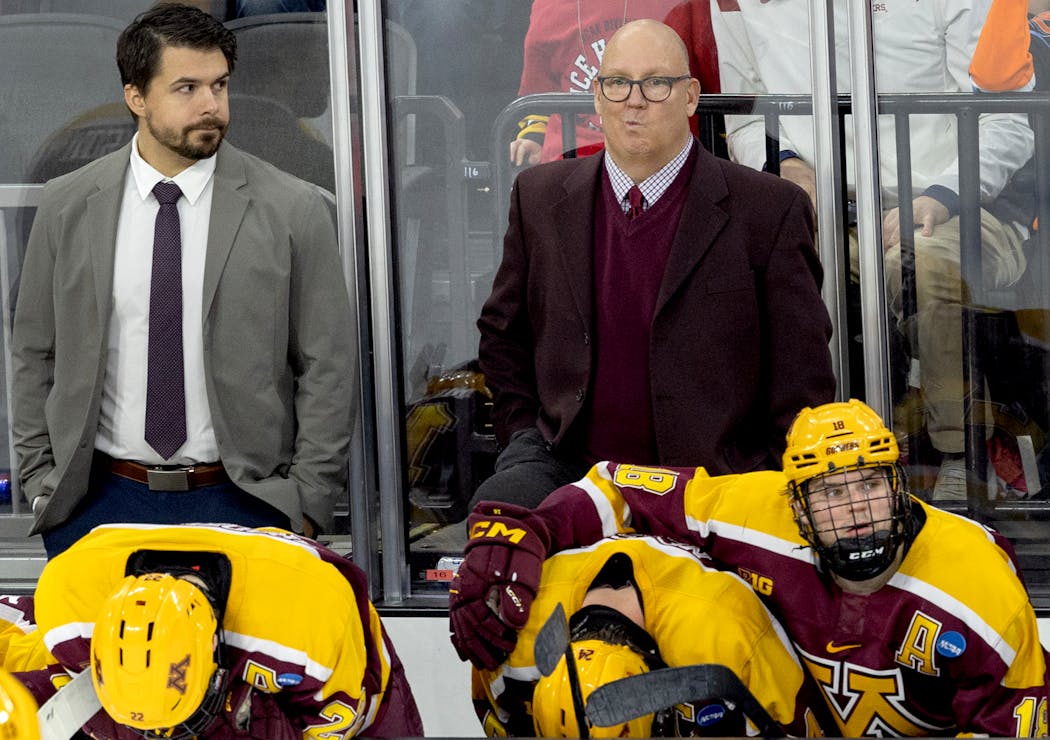Gophers coach Bob Motzko and players on the bench react at the end of the loss Saturday night in Sioux Falls.