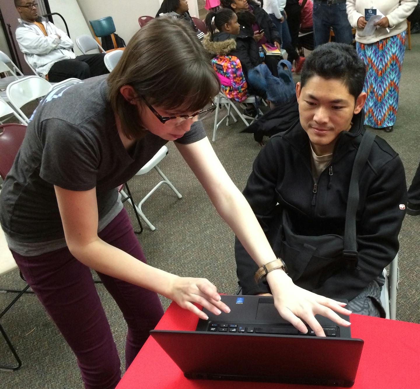 Gail Rosenblum/Star Tribune Christie Roberts of PCs for People registers Shano Ayela for low-cost internet thanks to a collaboration with Comcast.