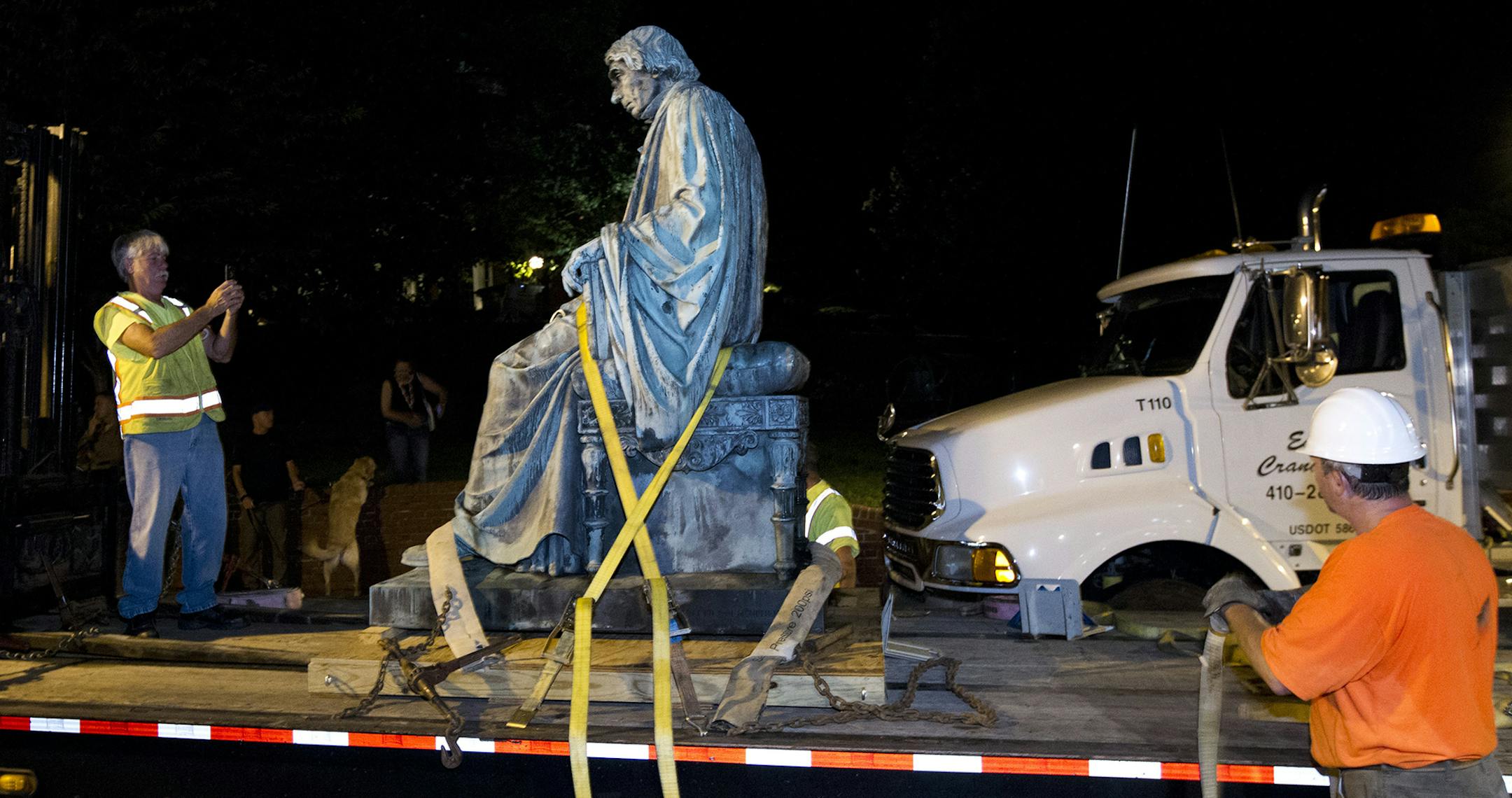Workers strap down the monument dedicated to U.S. Supreme Court Chief Justice Roger Brooke Taney on a flatbed truck after it was removed from outside the Maryland State House, in Annapolis, Md., early Friday, Aug. 18, 2017. Maryland workers hauled several monuments away, days after a white nationalist rally in Charlottesville, Virginia, turned deadly. ( AP Photo/Jose Luis Magana) ORG XMIT: MIN2017082114280058