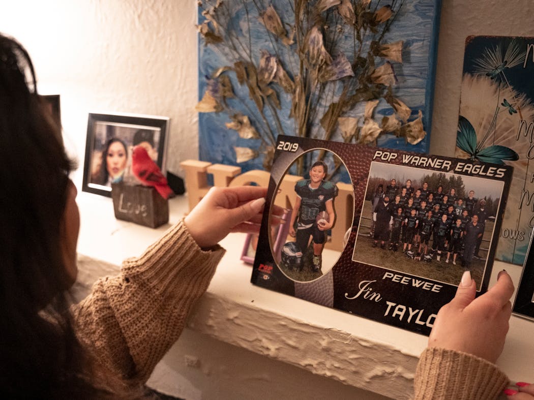 Baky Mikaele brought her late son Jin Taylor’s school football team portrait to the front of the mantle in her home in Minneapolis ons Jan. 16.