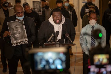 George Floyd’s brother, Philonise Floyd, left, looked on as Floyd’s nephew Brandon Williams spoke to a group of Black men at City Hall in Minneapo