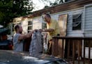 Jerry Wonsewicz, 80, right, gets help moving his belongings from his one Gary Wonsewicz, 57, both residents of Lowry Grove mobile home park on June 30