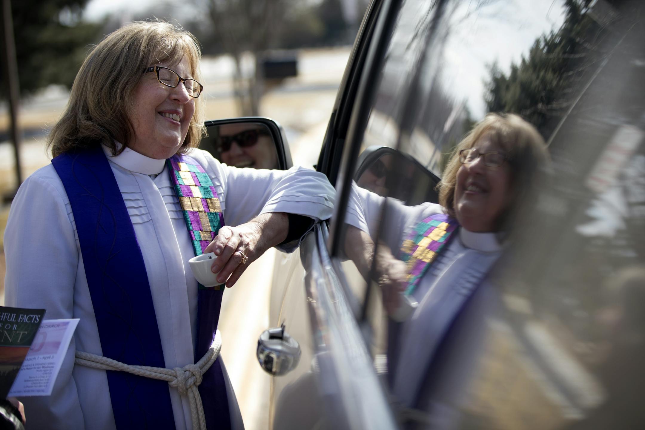 Pastor Christine Chiles left greeted Noreen Faulkner as she arrived during a drive through service of Ash Wednesday March 1, 2017 in at Maple Grove Lutheran Church in Maple Grove, MN.