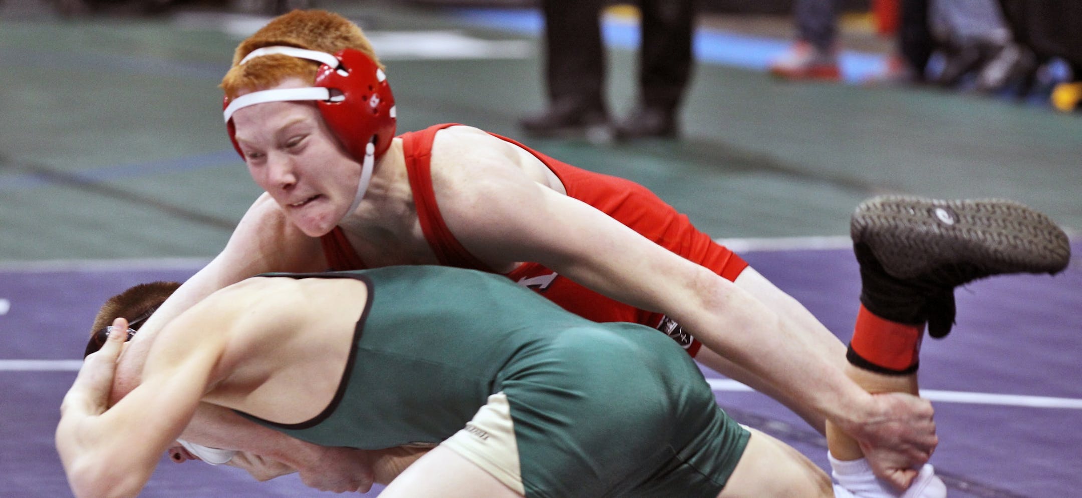 Jarred Oftedahl, Benilde-St. Margarets, top, wrestled Kyle Schoenecker of Chisago Lakes at the state wrestling meet.