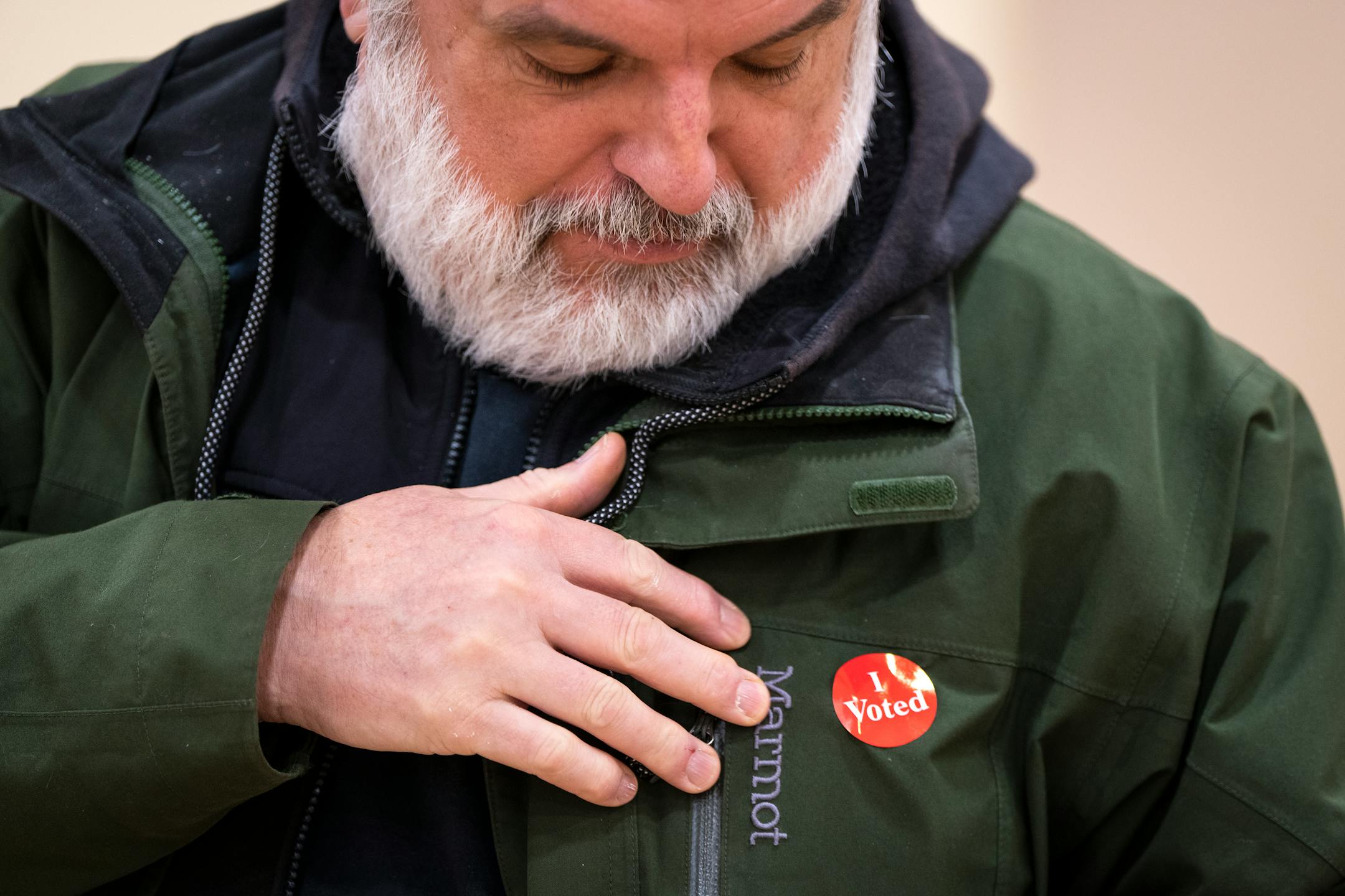 Chris Thorn puts on his sticker after voting at Jimmy Lee Recreation Center on Election Day in Ward 1 of St. Paul.