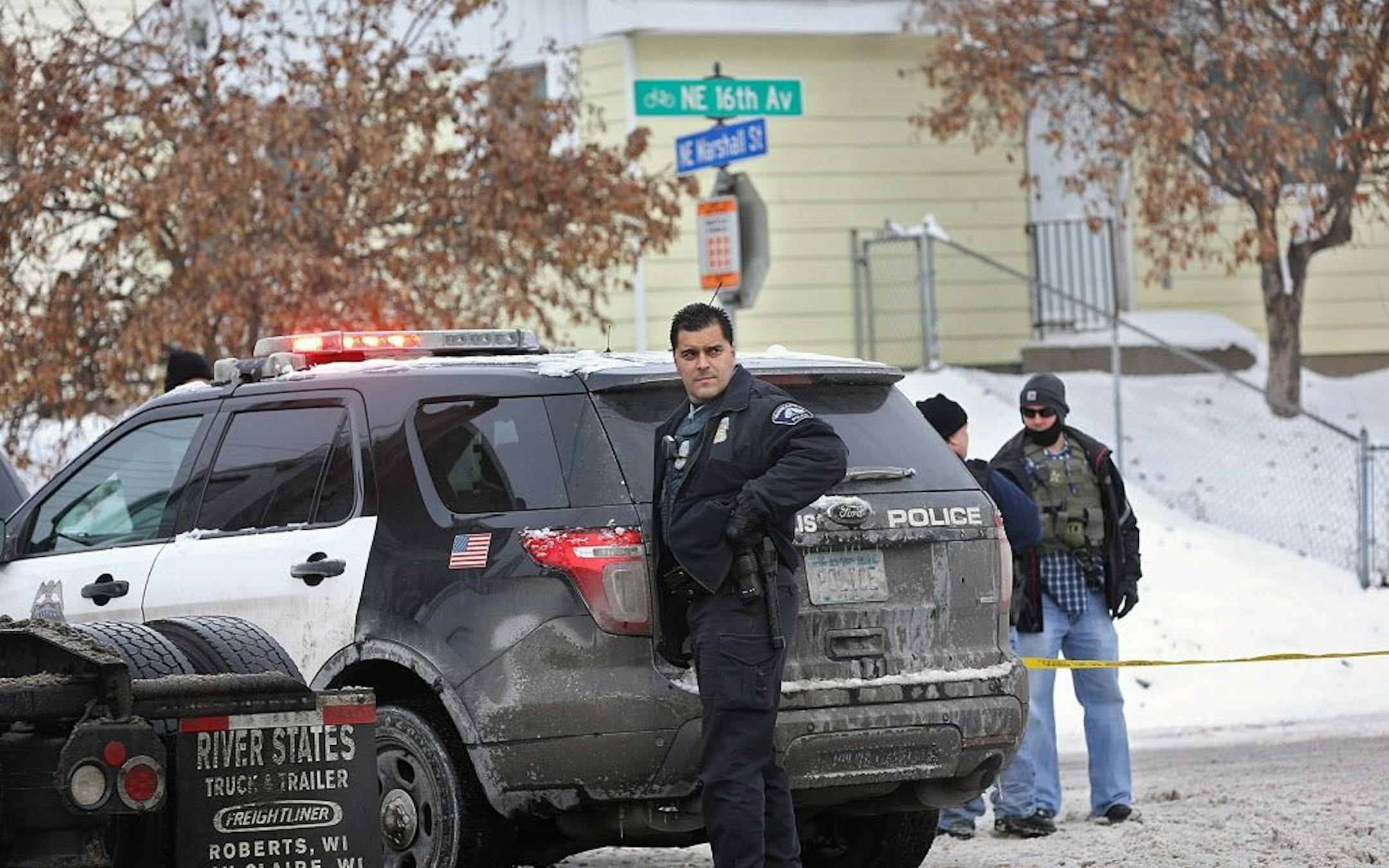 Police officers investigated an area along NE 16th Ave. near NE Marshall St., where federal agents were involved in gunfire while taking Buck O. White into custody in January 2014.