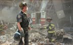 (NYT114) NEW YORK -- Aug. 8, 2002 -- 9-11-ANNIVERSARY-14 --Firefighters and a police officer just after the collapse of the World Trade Center on Sept