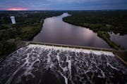 Water flows through the Coon Rapids Dam Tuesday afternoon.