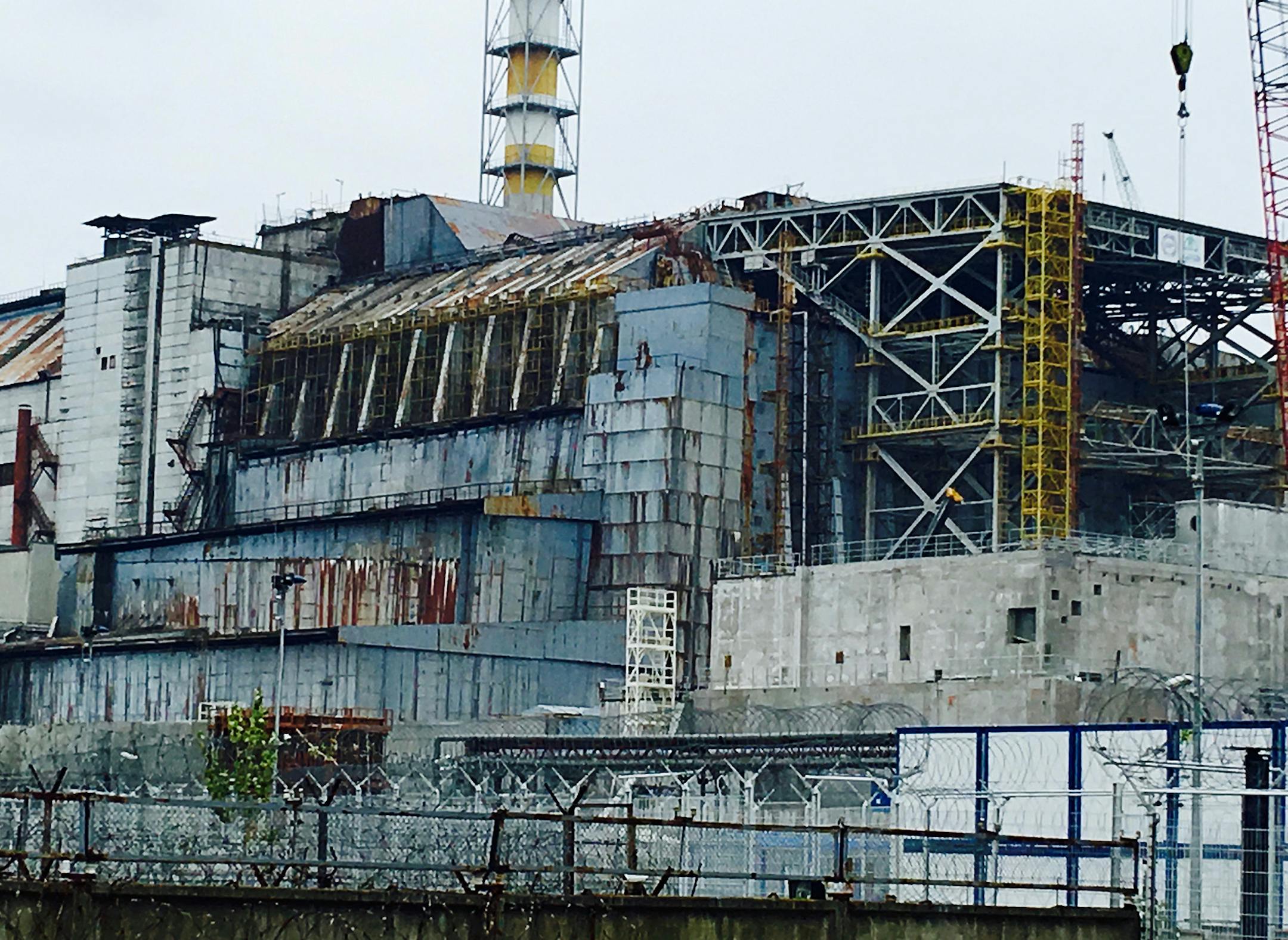 The crumbling sarcophagus that covered the remains of the ill-fated reactor No. 4, seen here not long before the new containment shield was rolled over the structure in November 2016. (Cheryl L. Reed/Chicago Tribune/TNS)