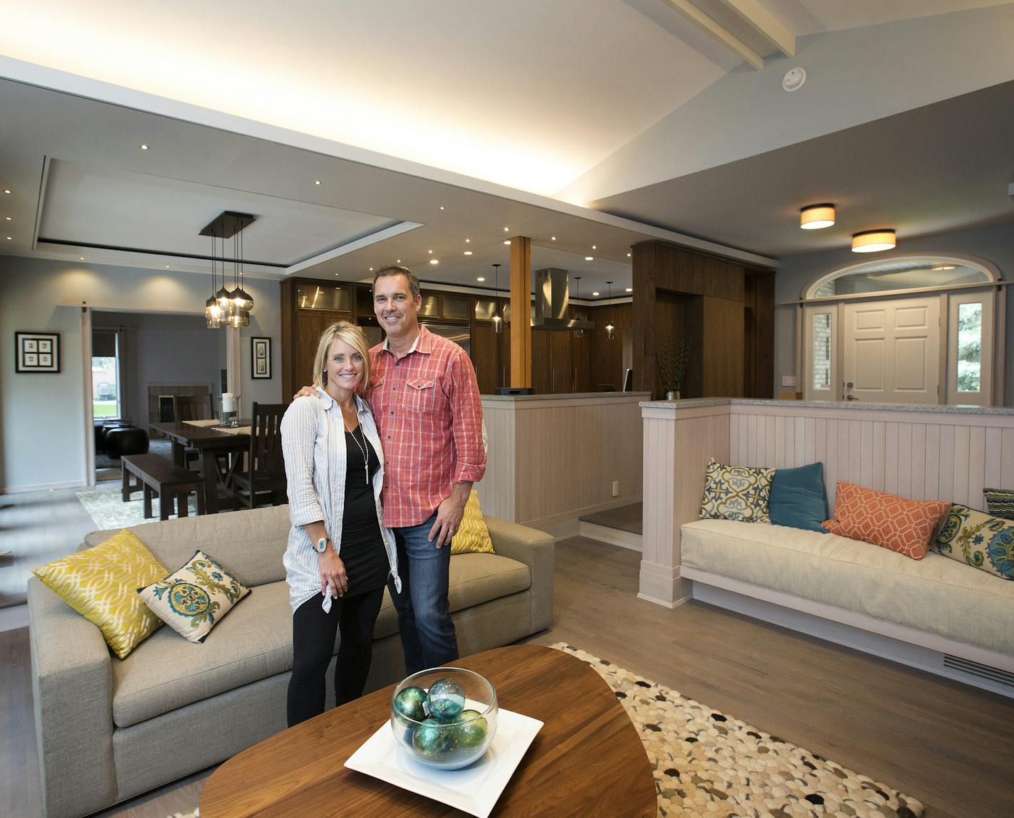 Lisa and Kurt Niederloh updated the main living spaces of their 1990s rambler by knocking down two walls and adding whitewashed wood, streamlined soffits and walnut cabinets.