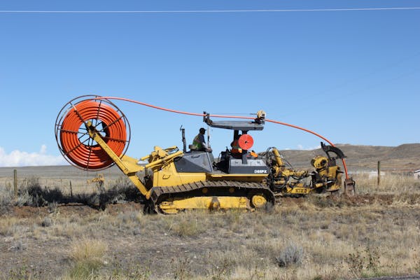A worker for Brooklyn Park-based Turtle Island Communications installs optical fiber with a cable plow on the Wind River Indian Reservation in Wyoming
