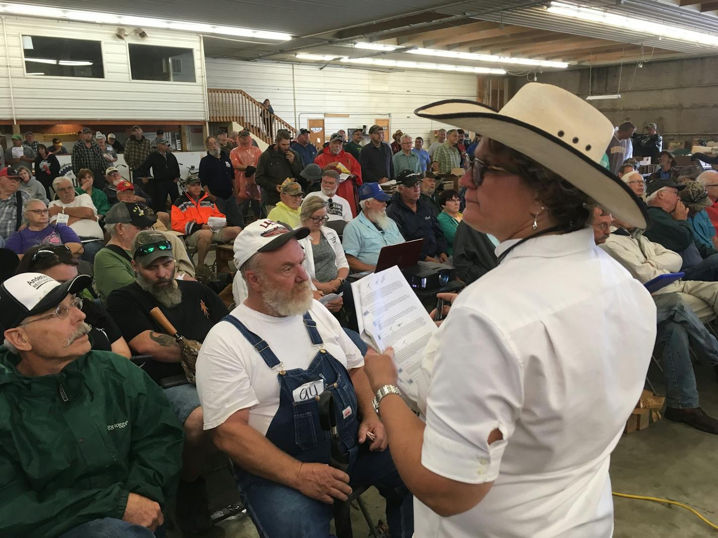 Yvette VanDerBrink looks over the crowd at a recent auction in Zimmerman, Minn.