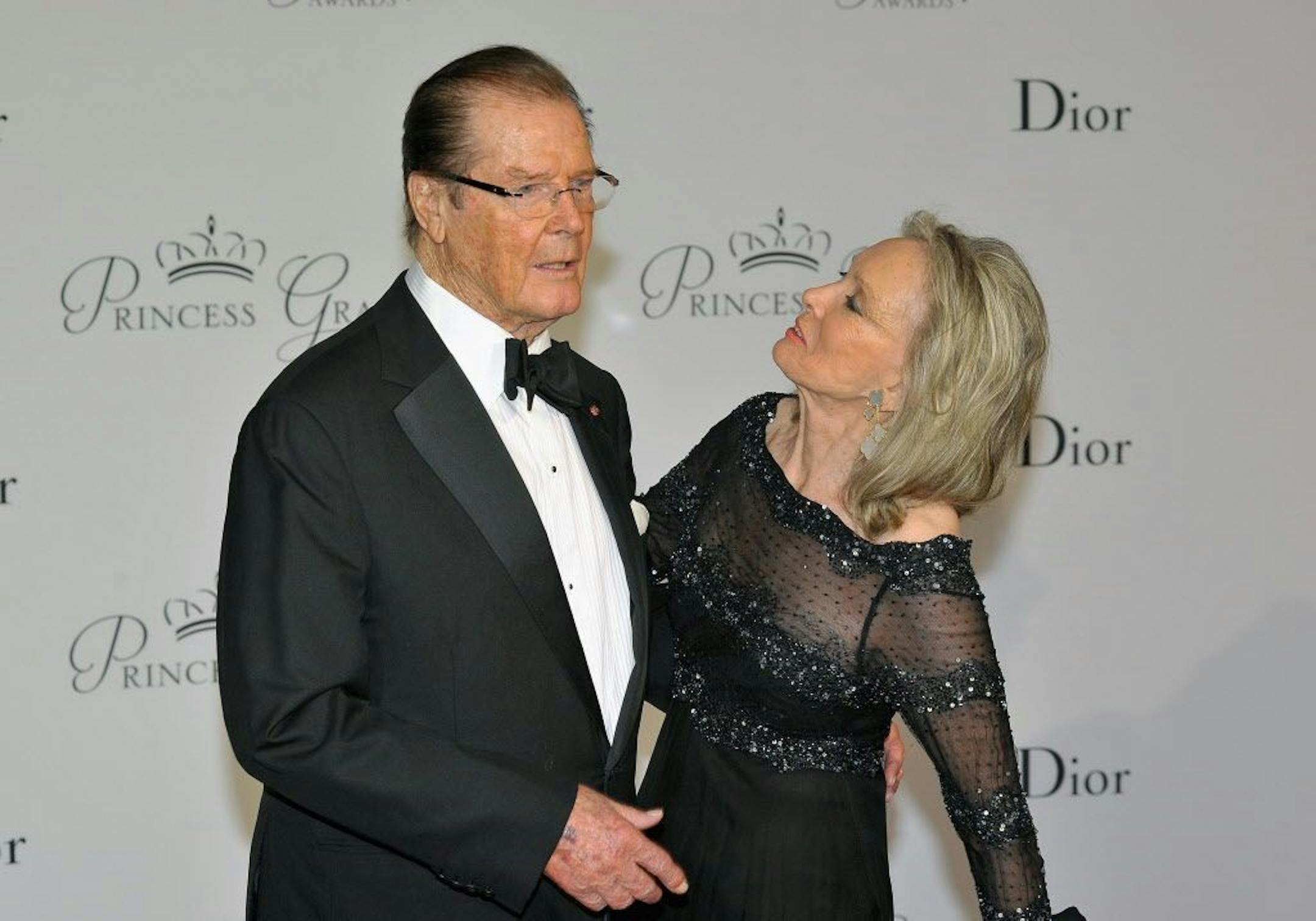FILE - In this Sept.5, 2015, file photo, actor Roger Moore, left, and his wife Kristina Tholstrup pose on the red carpet as they arrive at the Monaco palace to attend the Princess Grace Foundation gala in Monaco. Moore announced the death of Tholstrup's daughter, Christina Knudsen, on social media and his official website Tuesday, July 26, 2016.