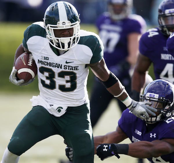 Michigan State running back Jeremy Langford (33) shakes off Northwestern safety Ibraheim Campbell (24) on a touchdown scoring run during the second ha