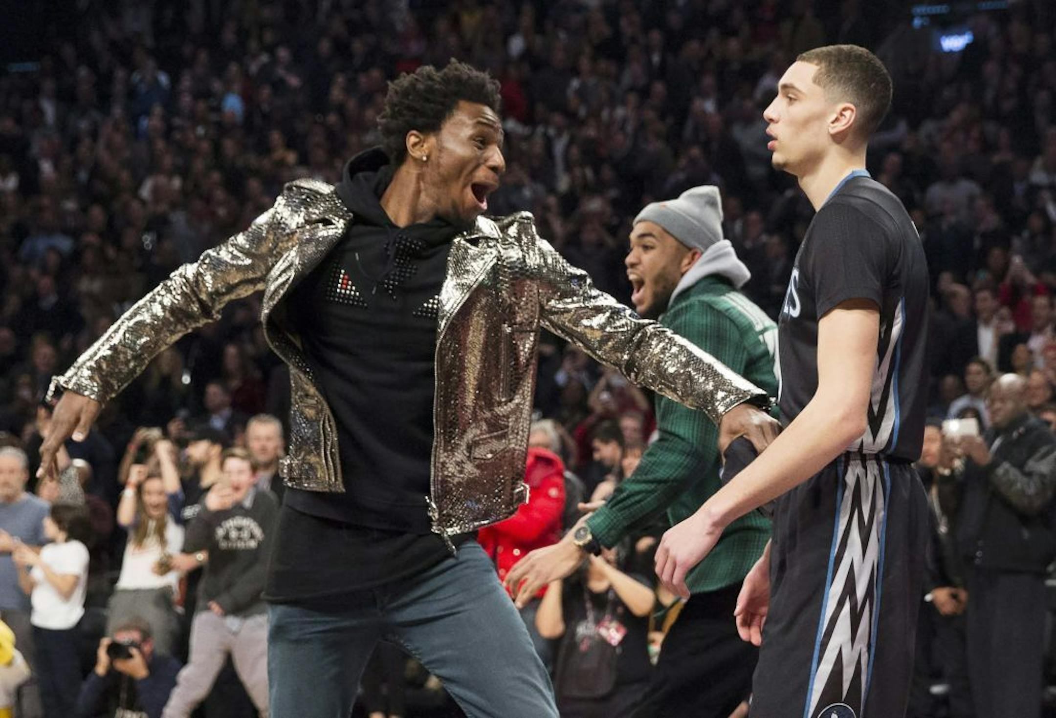 Minnesota Timberwolves' Zach LaVine, right, and Timberwolves teammate Andrew Wiggins react after LaVine's slam dunk during the NBA all-star skills competition in Toronto on Saturday, Feb. 13, 2016. (Mark Blinch/The Canadian Press via AP) MANDATORY CREDIT