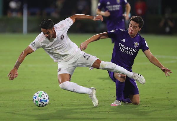 Inter Miami's Nicolas Figal (5) and Orlando City's Mauricio Pereyra battle for the ball during the MLS is Back tournament at Disney's ESPN Wide World 
