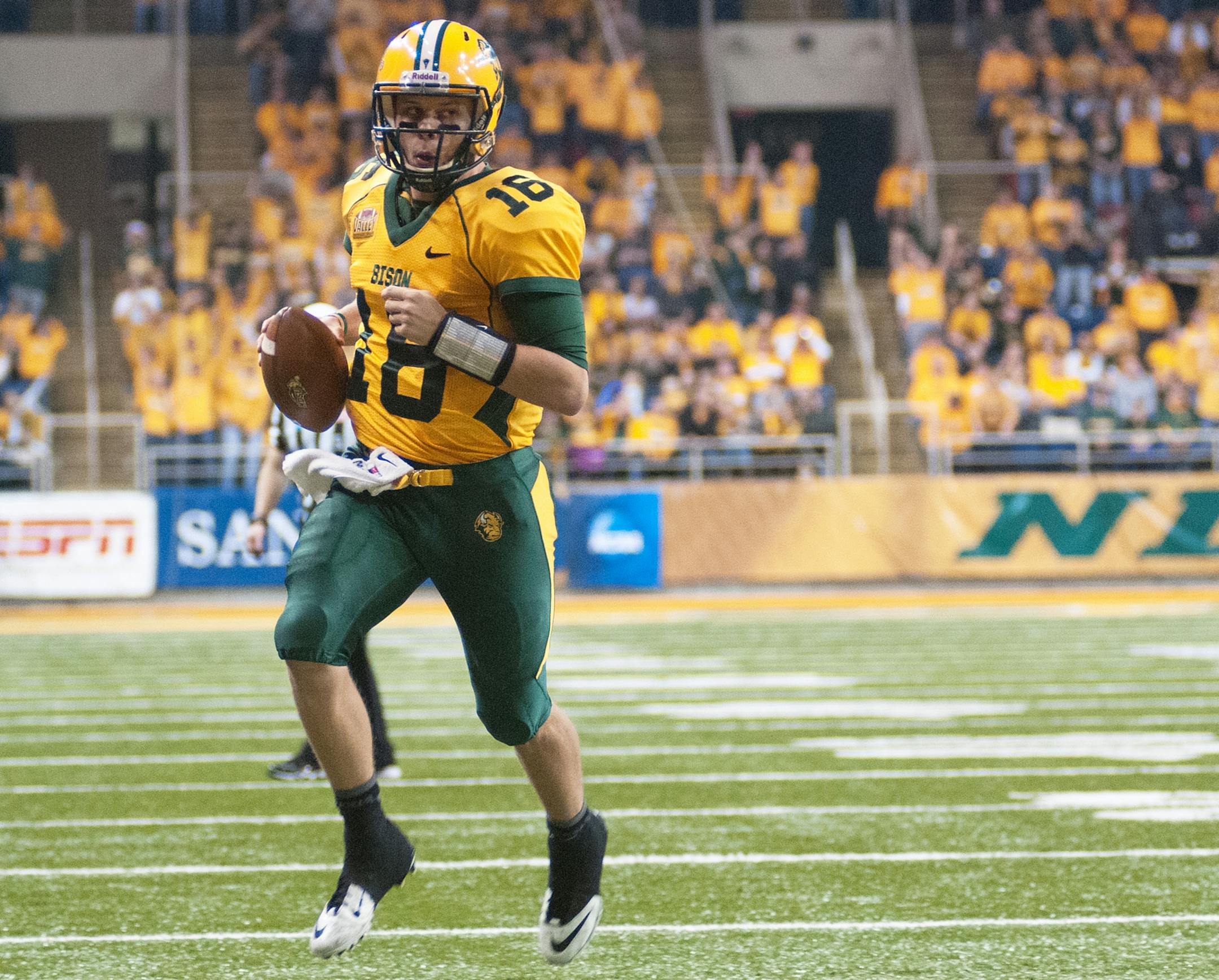 North Dakota State quarterback Brock Jensen scores a first half touchdown against Coastal Carolina during an NCAA college football game in the quarterfinals of the Football Championship Subdivision playoffs Saturday, Dec. 14, 2013, in Fargo, N.D. (AP Photo/Kevin Cederstrom)